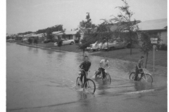 Young boys on bicycles in flood waters, corner of Walnut and Lawson Streets August 1961