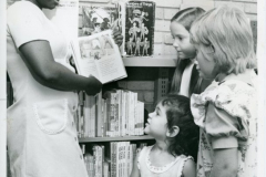 Central Library Librarian, Mabel Ajala, showing books to children