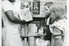 Central Library Librarian, Mabel Ajala, showing books to children