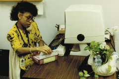 Woman at desk, Old computer terminal