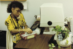 Woman at desk, Old computer terminal