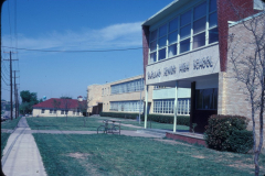 Southeast entrance to Garland Senior High School Ave D and 12th St.  This part of the building was previously first Garland Junior High School and Emmit O. Bussey Middle School.   April 1980