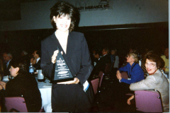 Cara Harting, Director of Community relations at an event with award