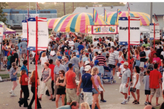 Star Spangled Fourth 2000 - midway to rides - includes signs for Raytheon, the Dallas Morning News and other sponsors.