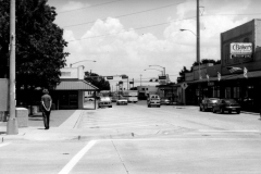 Sixth & Main Street, looking east On right side of photo, right to left: Baker's Furniture Gallery, followed by Garland Furniture  On left side of photo, edge of square, Nuway Athletic Club at 114 N Sixth Street On right side of photo, right to left: Baker's Furniture Gallery, next to future home of the Ivy Cottage, followed by Garland Furniture  On left side of photo, edge of square, Nuway Athletic Club at 106 N Sixth Street