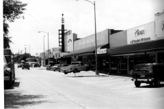 Looking west down Sixth Street. From east to west: Plaza Theatre--labeled in picture as Texas Opra House, then H.W. Jones Hardware Co., Books 'N Stuff, The Farmhouse Antiques, and Minuteman Press.