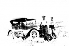 Two men in front of vintage car